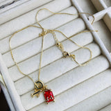 Charm Maleta Dorada