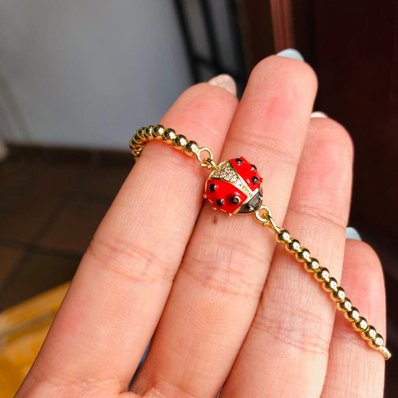 Pulsera mariquita dorada